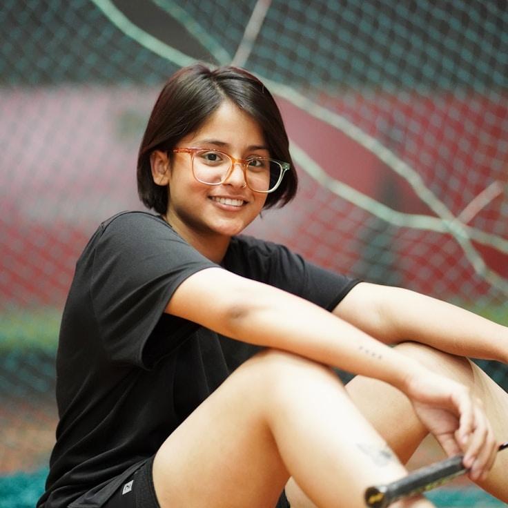 Avery Chen, Lead Design Curator at MapleSeedPaper, reviewing corporate floral arrangements